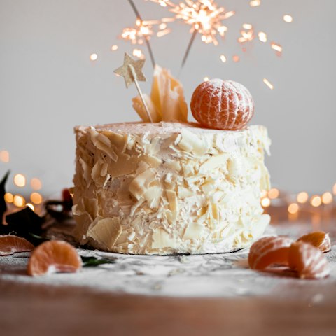 A birthday cake with a lit sparkler