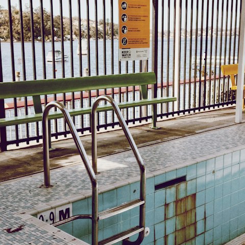 A swimming pool behind a fence