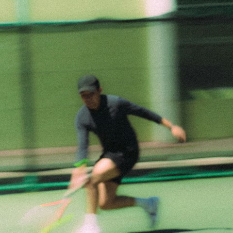 A tennis player hitting a ball on a court