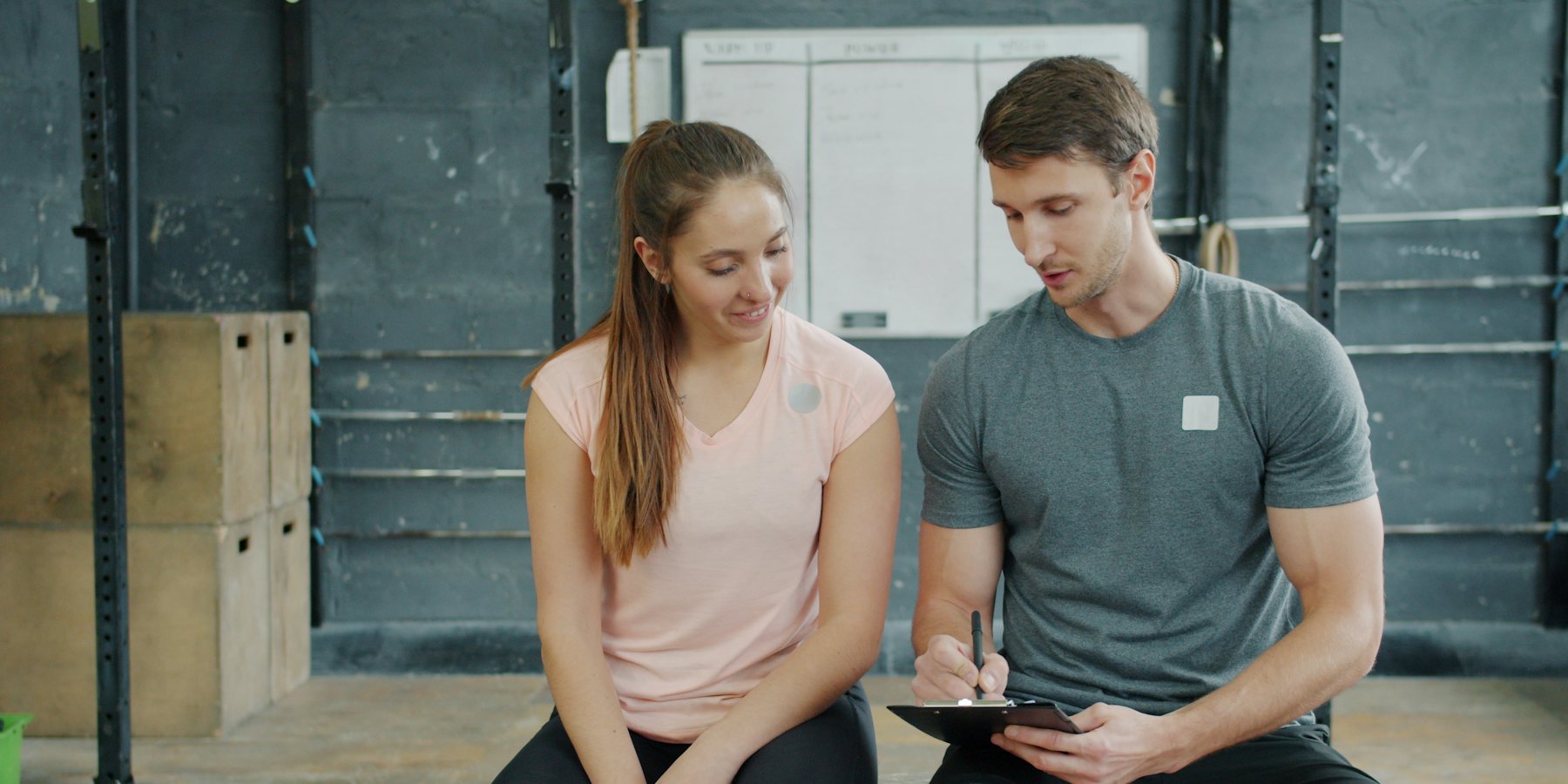A personal trainer and client going over a workout plan